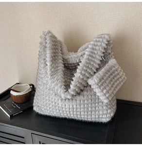Detail of grey faux fur tote bag with textured checkered pattern and matching pouch