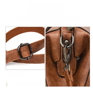 Detail of glossy dark metal hardware and vintage brown leather texture on handbag