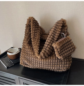 Close-up of brown plush tote bag set featuring striped faux fur texture and small pouch