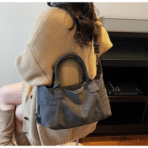 Grey frosted leather tote bag detail showing smooth texture and adjustable shoulder strap