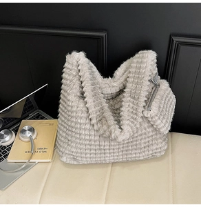 Detailed view of light gray striped faux fur tote bag with matching zipper pouch