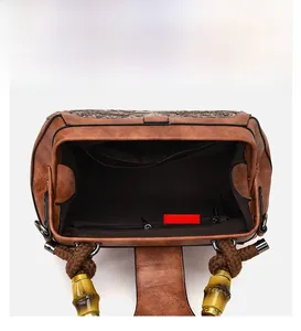 Detail view of the spacious inner compartments and retro bamboo handle of the brown handbag