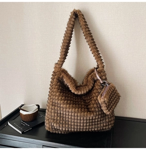 Detail of caramel plush tote bag with lattice texture and matching small coin purse charm