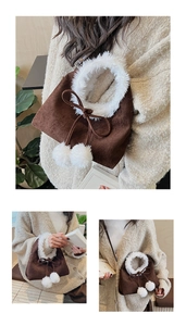 Detail showing plush white faux fur trim and soft pompom charms on the brown suede bucket bag