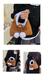 Detail of a brown suede bucket bag with white plush trim and fuzzy pom-poms accents