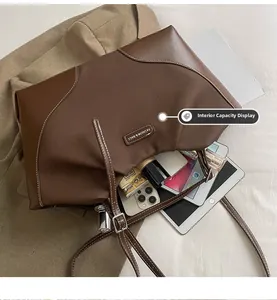 Spacious interior of canvas and leather tote bag showing iPad and phone storage