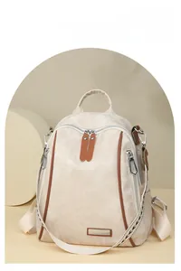 Close-up of soft cream PU leather backpack with durable zippers and brown trim details