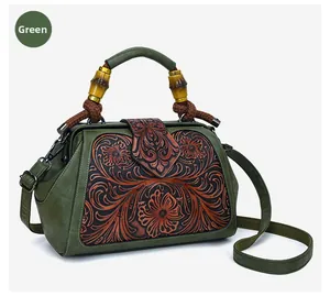 Detail of green vintage floral embossed bag with retro bamboo handle and strap