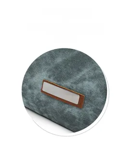 Close-up of the stylish rectangular metal plate and denim texture on the casual backpack