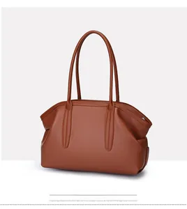 Detail of vintage brown tote bag showing lychee grain leather and long double handles