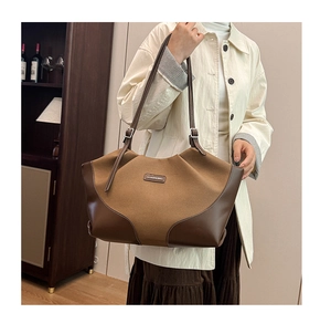 Detail of the vintage contrast leather tote with metal buckle and fashion logo plate