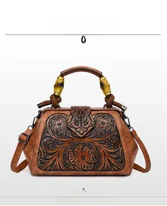 Detail view of retro handbag featuring embossed black floral patterns and bamboo handle