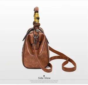 Side view of retro brown leather bag with bamboo handle and braided strap detail
