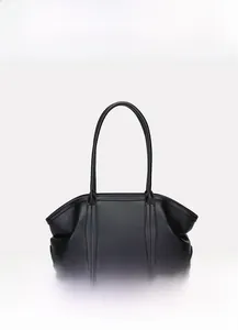 Detail of premium black pebble grain leather texture on the large commuter tote bag
