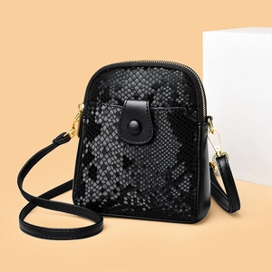 Minimalist black faux snakeskin crossbody bag with gold hardware and front pocket