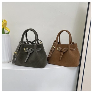 Detail of dark grey and brown bucket bags with buckle accents and contrast stitching