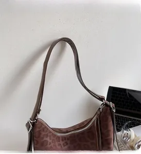 Close-up of leopard print hobo bag showing soft suede texture and silver metal zipper