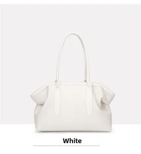 Detailed view of large white pebble leather tote bag with long slim shoulder straps