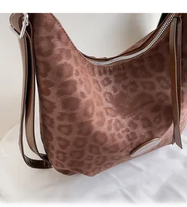 Detail of soft leopard print hobo bag showing brown texture and silver buckle strap