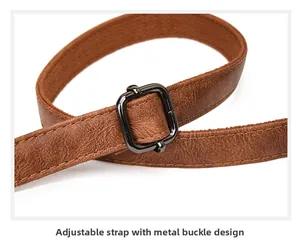 Detail of adjustable brown leather strap with gunmetal buckle and stitching