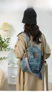 Detail showing vintage blue canvas backpack with ethnic patterned strap and side pocket