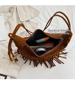 Detail view of large interior space with zipper pocket in brown suede fringe handbag