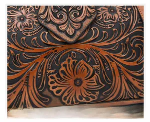 Macro shot of embossed vintage floral and vine patterns on bicolored leather surface