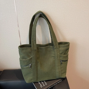 Olive green corduroy tote bag with dual front zipper pockets for daily work commute