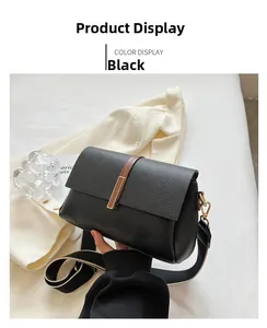 Close-up of black lychee grain crossbody bag with wide black and white woven strap