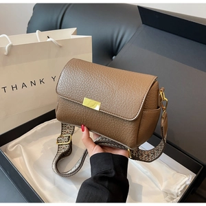 Brown lychee leather square crossbody bag with jacquard strap in elegant gift packaging