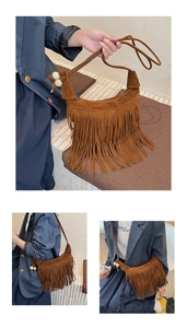Detail of bohemian brown suede crescent bag with long fringes and wooden beads