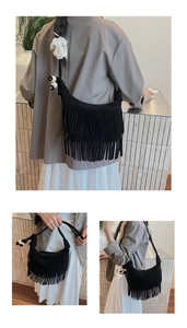 Detail of black suede hobo bag featuring long tassels and decorative black and white beads