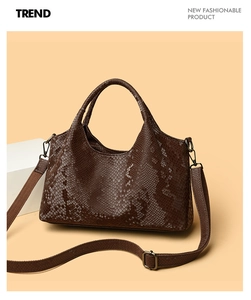 Close-up of deep brown snakeskin pattern and dual strap detail on large tote bag