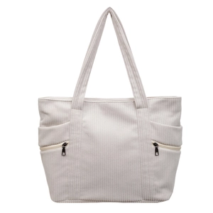Off-white corduroy tote bag with dual zipper pockets on a clean white background