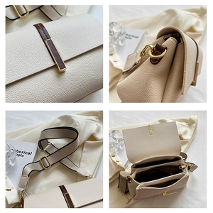 Detail of cream crossbody bag showing lychee grain leather, gold hardware, and multi-layer interior