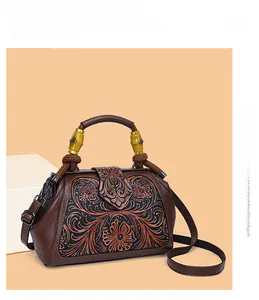 Close-up of retro floral embossed leather bag with unique bamboo handle and woven knot