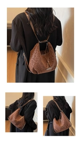 Detail of soft leopard print hobo bag with leather straps and velvet texture finish