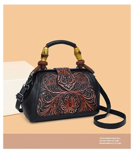 Detail of vintage tote bag featuring embossed peony patterns and a bamboo handle
