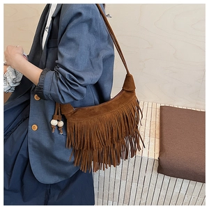 Close-up of hobo bag featuring double-layered long tassels and decorative wooden beads
