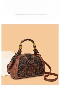 Detail of retro floral embossed leather bag with unique bamboo handle and shoulder strap