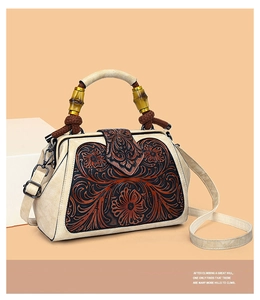Detail of vintage tote with floral embossing, bamboo handle and detachable strap