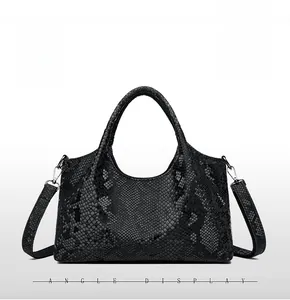 Front view of black snakeskin pattern shoulder bag with detachable strap details