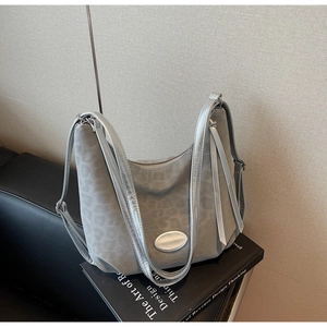 Close-up of gray leopard print handbag with suede texture and silver metal hardware