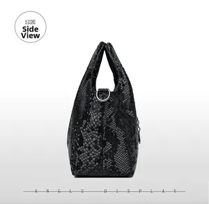 Side view detail of a black snakeskin textured shoulder bag with metallic D-ring hardware