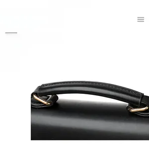 Detail of leather handbag handle with premium stitching and gold metal hardware