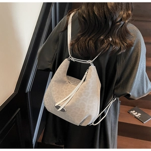 Detail of grey leopard print hobo bag featuring silver hardware and tassel drawstring