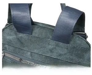 Macro view of reinforced stitching and durable blue fabric shoulder strap of the backpack