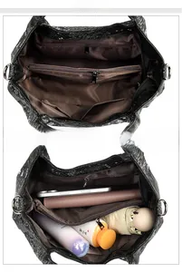 Detailed interior of snakeskin embossed tote with multiple compartments and zipper pockets