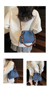 Detail view of blue denim bucket bag with brown woven handle and leather logo patch