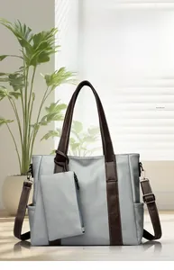Detail of light blue tote bag with dark brown straps and attached zipper coin pouch